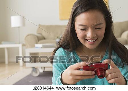 Portrait of teenage girl (16-17) with digital camera View Large Photo Image Picture - Portrait of teenage girl (16-17) with digital camera. Fotosearch