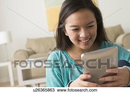 Portrait of teenage girl (16-17) with digital tablet View Large Photo Image Stock Image - Portrait of teenage girl (16-17) with digital tablet. Fotosearch