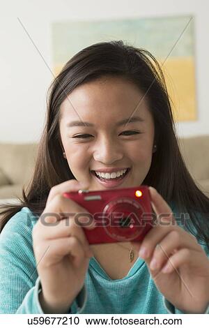 Portrait of teenage girl (16-17) with digital camera View Large Photo Image Stock Image - Portrait of teenage girl (16-17) with digital camera. Fotosearch