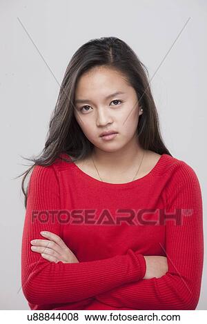 Portrait of teenage girl (16-17) with arms crossed View Large Photo Image Stock Photo - Portrait of teenage girl (16-17) with arms crossed . Fotosearch