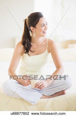Portrait of woman relaxing in bedroom View Large Photo Image Stock Image - Portrait of woman relaxing in bedroom. Fotosearch