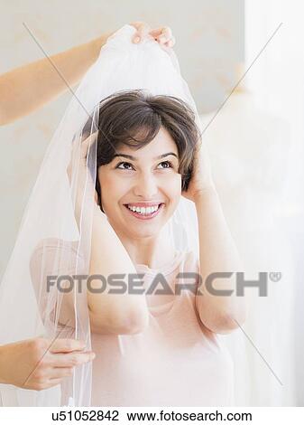 Portrait of woman trying on wedding veil View Large Photo Image Stock Image - Portrait of woman trying on wedding veil. Fotosearch