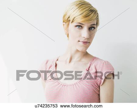 Portrait of young smiling woman, studio shot View Large Photo Image Stock Image - Portrait of young smiling woman, studio shot. Fotosearch