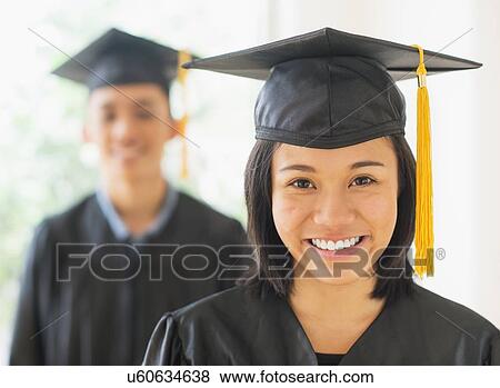 Portrait of young woman and young man wearing graduation gown View Large Photo Image Stock Photo - Portrait of young woman and young man wearing graduation gown. Fotosearch