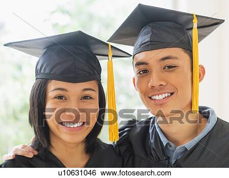 Portrait of young woman and young man wearing graduation gown View Large Photo Image Stock Photograph - Portrait of young woman and young man wearing graduation gown. Fotosearch