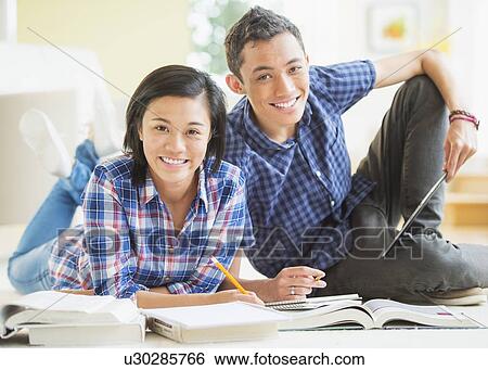 Portrait of young woman and young man learning View Large Photo Image Stock Photograph - Portrait of young woman and young man learning. Fotosearch