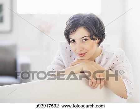 Stock Image - Portrait of young woman daydreaming. Fotosearch