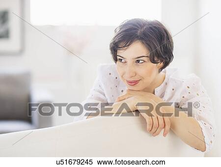 Stock Photography - Portrait of young woman daydreaming. Fotosearch
