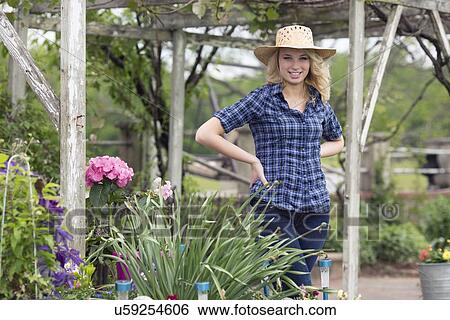 Portrait of young woman in garden View Large Photo Image Stock Photograph - Portrait of young woman in garden. Fotosearch