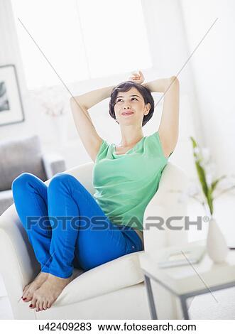 Portrait of young woman relaxing at home View Large Photo Image Stock Image - Portrait of young woman relaxing at home. Fotosearch