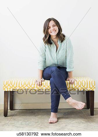 Stock Image - Portrait of young woman smiling. Fotosearch