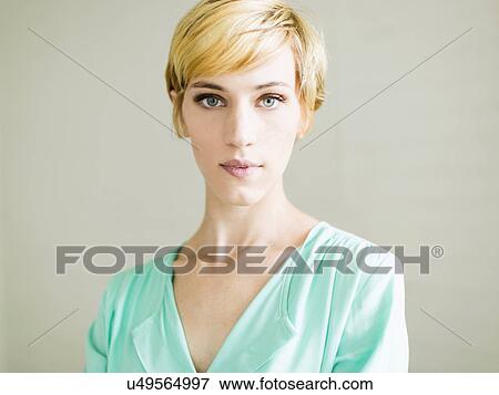 Stock Photo - Portrait of young woman, studio shot. Fotosearch