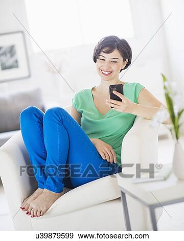Portrait of young woman using mobile phone View Large Photo Image Stock Photo - Portrait of young woman using mobile phone. Fotosearch