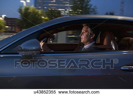 Stock Photography - Profile of businessman driving car. Fotosearch