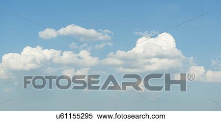 Stock Photography - Puffy clouds on blue sky. Fotosearch