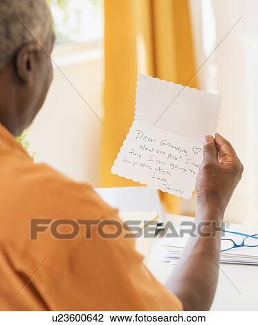 Rear view of man reading message View Large Photo Image Stock Image - Rear view of man reading message. Fotosearch
