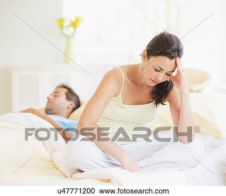 Sad woman in bedroom, man sleeping View Large Photo Image Stock Image - Sad woman in bedroom, man sleeping. Fotosearch