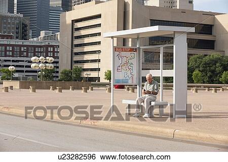 Senior man sitting at bus stop and text messaging View Large Photo Image Stock Photograph - Senior man sitting at bus stop and text messaging. Fotosearch