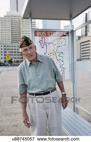 Stock Photo - Senior man standing at bus stop. Fotosearch