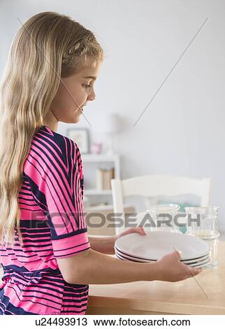 Side view of girl (8-9) holding plates View Large Photo Image Stock Image - Side view of girl (8-9) holding plates. Fotosearch