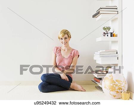 Smiling woman at home, studio shot View Large Photo Image Stock Image - Smiling woman at home, studio shot. Fotosearch
