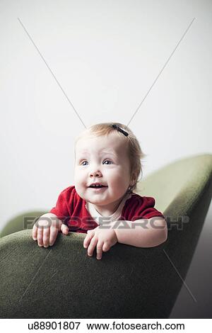 Studio portrait of baby girl (6-11 months) View Large Photo Image Stock Photo - Studio portrait of baby girl (6-11 months). Fotosearch