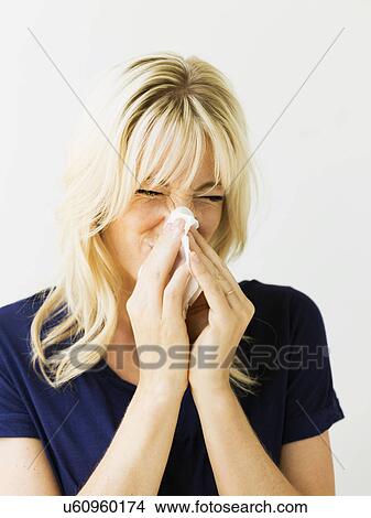 Studio portrait of blonde woman blowing nose View Large Photo Image Picture - Studio portrait of blonde woman blowing nose. Fotosearch