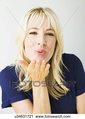 Studio portrait of blonde woman blowing kiss View Large Photo Image Stock Image - Studio portrait of blonde woman blowing kiss. Fotosearch