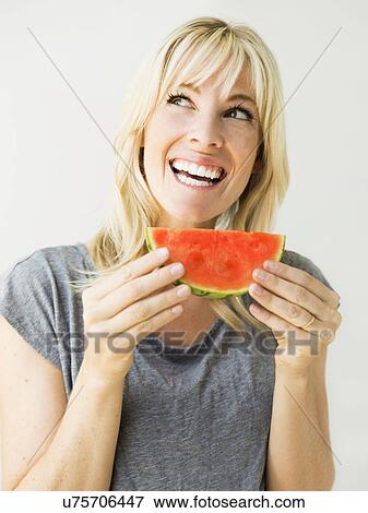 Studio portrait of blonde woman eating watermelon View Large Photo Image Stock Photo - Studio portrait of blonde woman eating watermelon. Fotosearch