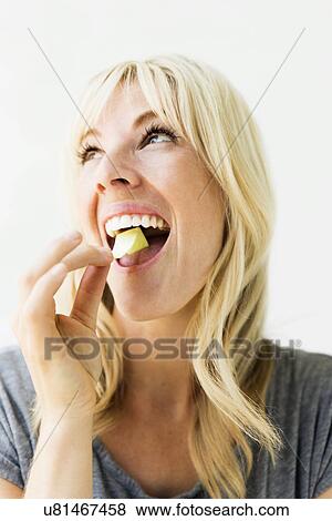 Studio portrait of blonde woman eating bubble gum View Large Photo Image Stock Photo - Studio portrait of blonde woman eating bubble gum. Fotosearch