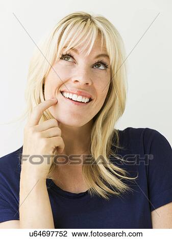 Studio portrait of blonde woman looking up View Large Photo Image Stock Image - Studio portrait of blonde woman looking up. Fotosearch