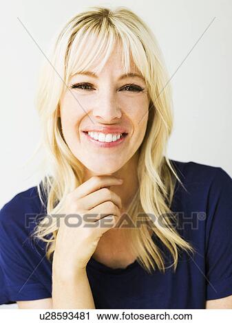 Stock Image - Studio portrait of blonde woman. Fotosearch