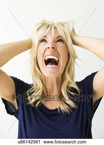 Studio portrait of blonde woman screaming View Large Photo Image Stock Image - Studio portrait of blonde woman screaming. Fotosearch