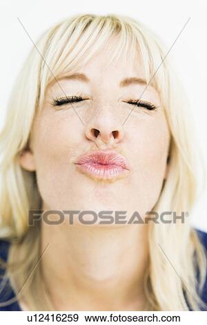 Studio portrait of blonde woman puckering View Large Photo Image Stock Photo - Studio portrait of blonde woman puckering. Fotosearch