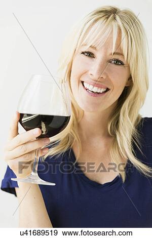 Studio portrait of blonde woman with wineglass View Large Photo Image Stock Photo - Studio portrait of blonde woman with wineglass. Fotosearch