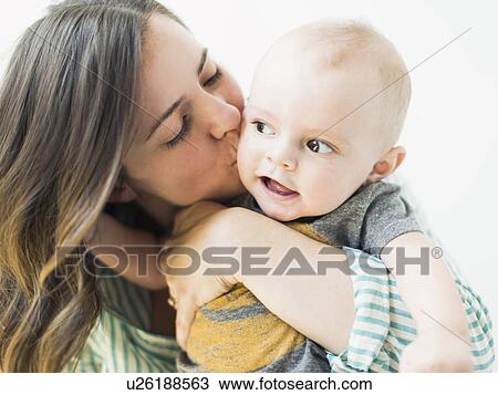 Studio portrait of mother holding baby boy (6-11 months) View Large Photo Image Stock Image - Studio portrait of mother holding baby boy (6-11 months). Fotosearch