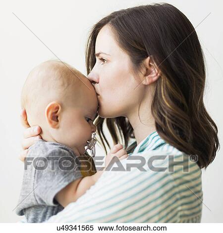 Studio portrait of mother kissing baby boy (6-11 months) View Large Photo Image Stock Photography - Studio portrait of mother kissing baby boy (6-11 months). Fotosearch