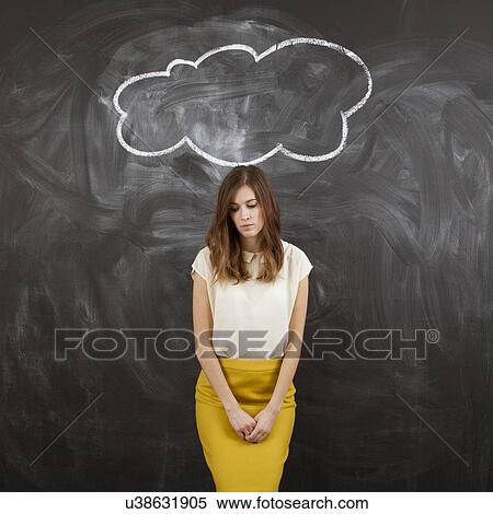 Stock Photography - Studio portrait of woman standing under chalk cloud. Fotosearch