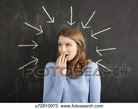 Stock Image - Studio portrait of woman surrounded with chalk arrows. Fotosearch