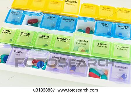 Stock Photo - Studio shot of colorful pill containers. Fotosearch