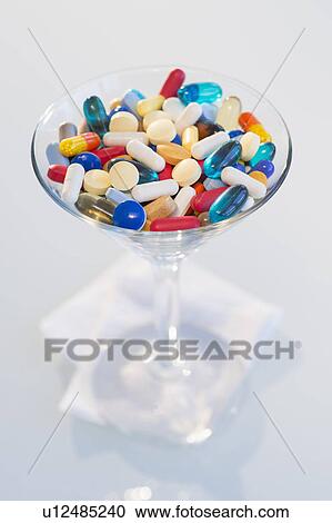 Studio shot of colorful pills in martini glass View Large Photo Image Stock Image - Studio shot of colorful pills in martini glass. Fotosearch