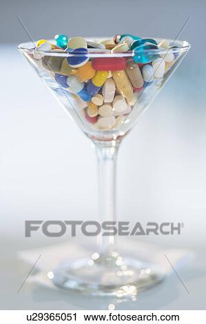 Studio shot of colorful pills in martini glass View Large Photo Image Stock Image - Studio shot of colorful pills in martini glass. Fotosearch