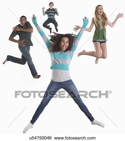Stock Photograph - Studio shot of four friends (12-13, 14-15) jumping on white background. Fotosearch