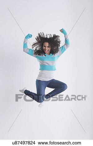 Picture - Studio Shot of girl (12-13) jumping. Fotosearch