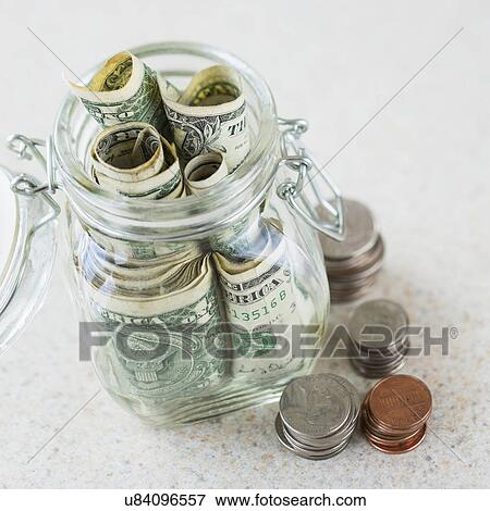 Studio shot of savings in jar View Large Photo Image Stock Photo - Studio shot of savings in jar. Fotosearch