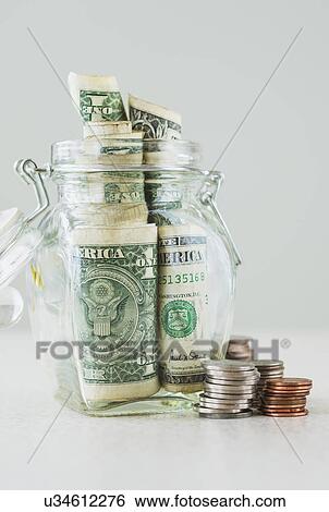 Stock Photograph - Studio shot of savings in jar. Fotosearch
