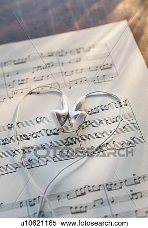 Stock Photography - Studio shot of sheet music with earphones. Fotosearch