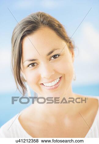 Stock Photo - Studio Shot of smiling woman with brown hair. Fotosearch