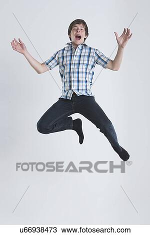 Studio Shot of teenage boy (14-15) jumping View Large Photo Image Stock Image - Studio Shot of teenage boy (14-15) jumping. Fotosearch