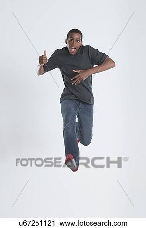 Studio Shot of teenage boy (14-15) jumping View Large Photo Image Stock Image - Studio Shot of teenage boy (14-15) jumping. Fotosearch